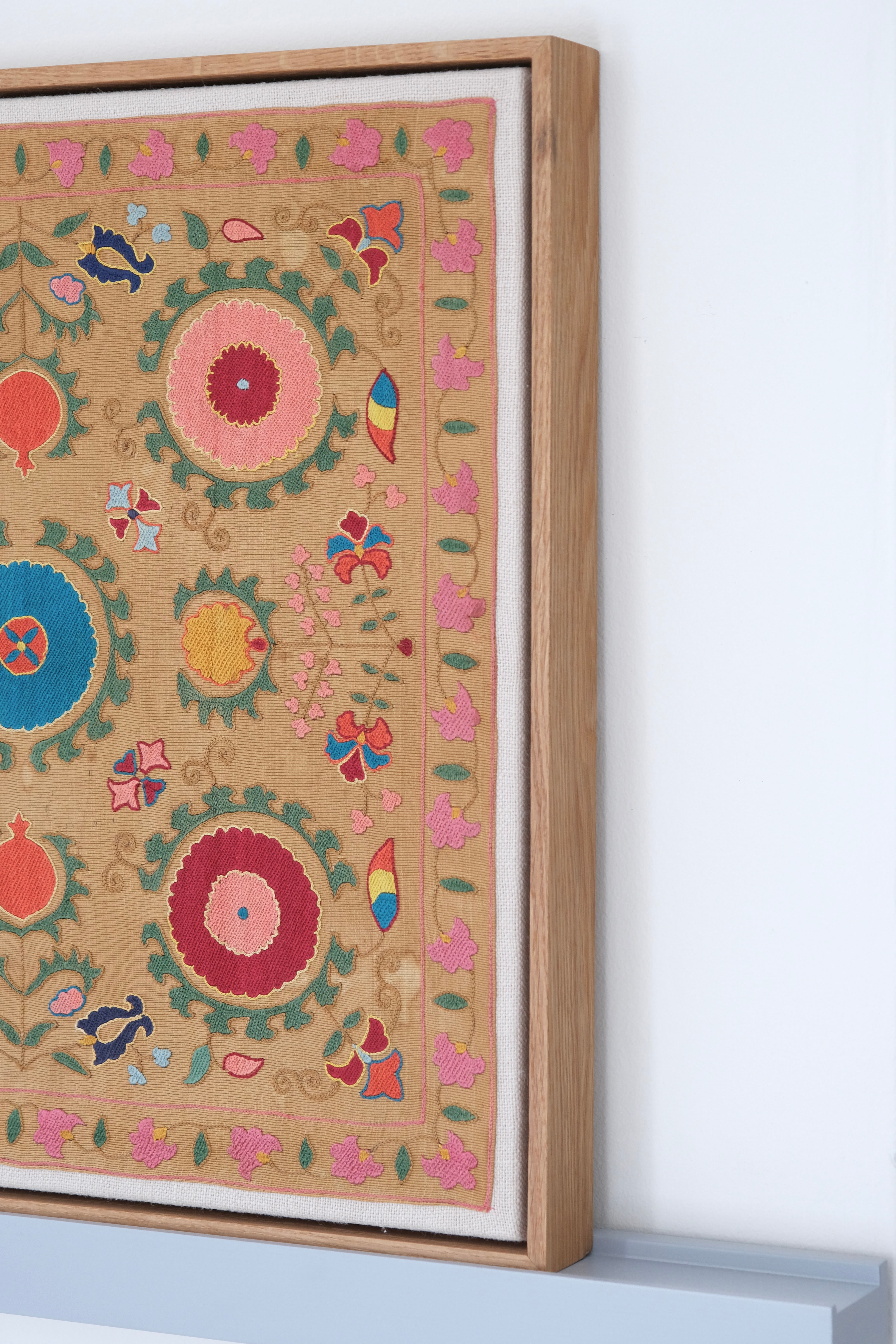 Framed antique suzani, framed textile, embroidered textile art, wooden frame, side view
