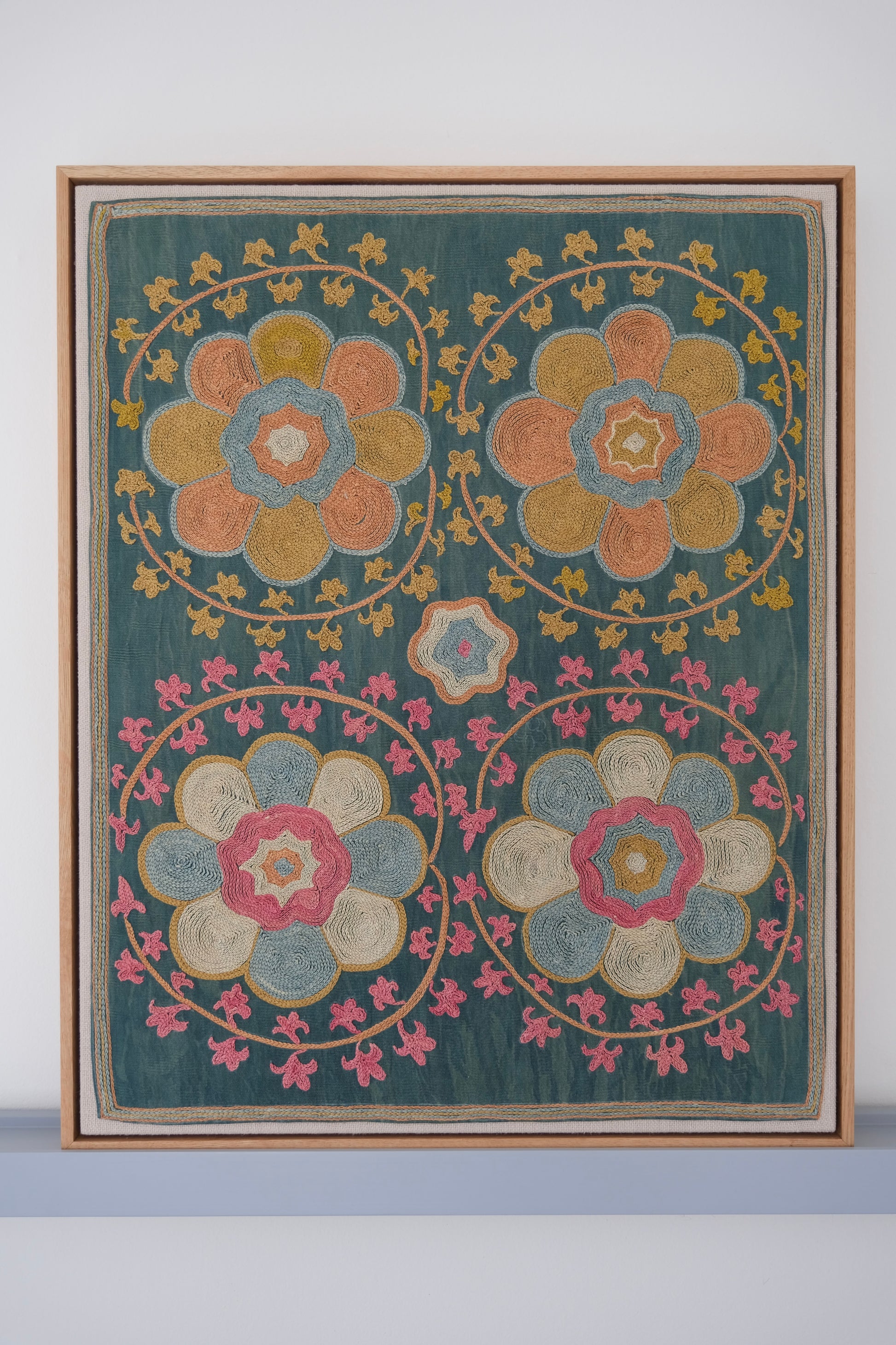 Framed suzani, embroidered textile art, wooden frame, green with orange and pink floral motifs
