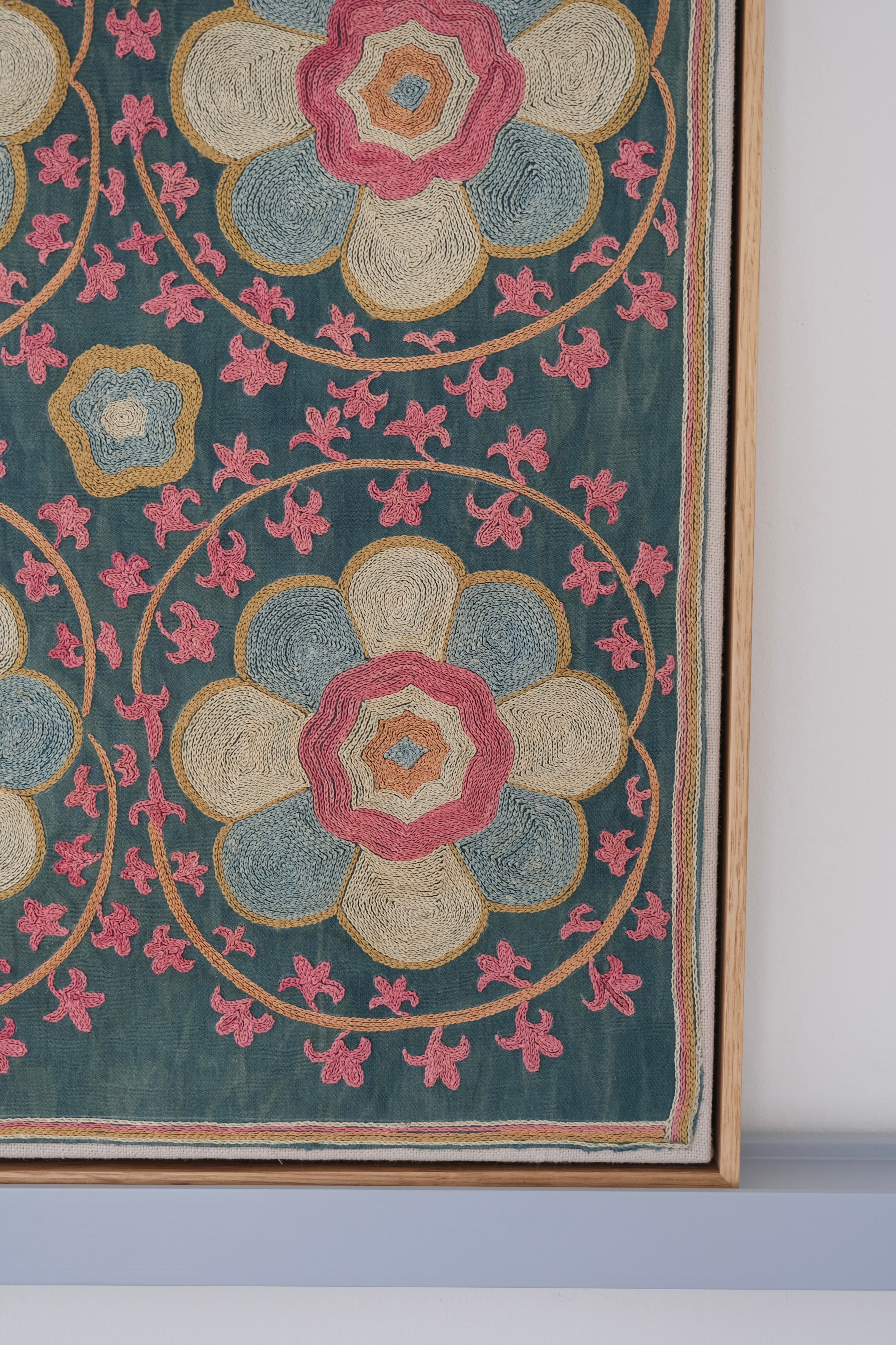 Framed suzani, embroidered textile art, wooden frame, green with florals, close-up