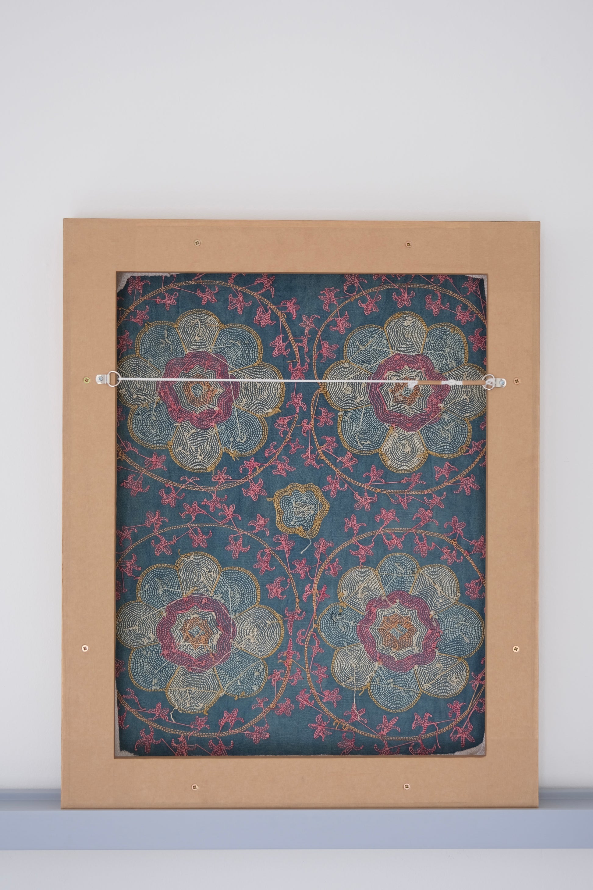 Framed suzani, embroidered textile art, wooden frame, green with florals, backside