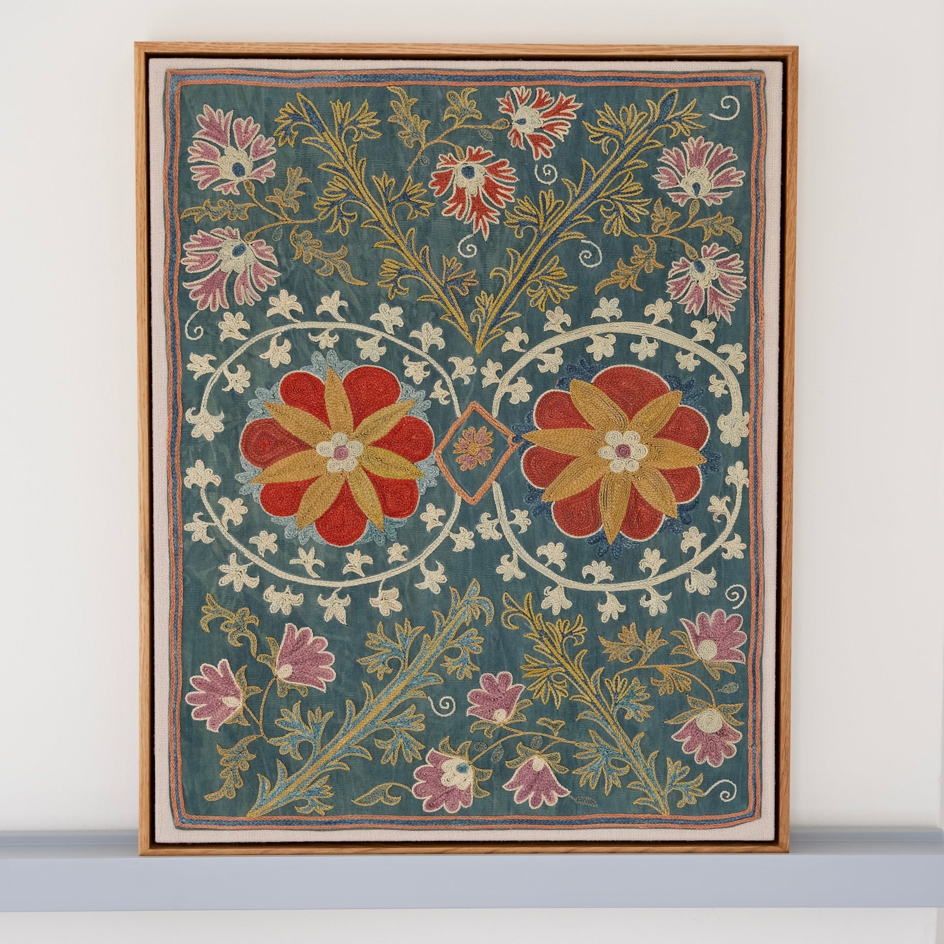 Framed suzani, embroidered textile art, wooden frame, green with floral motifs