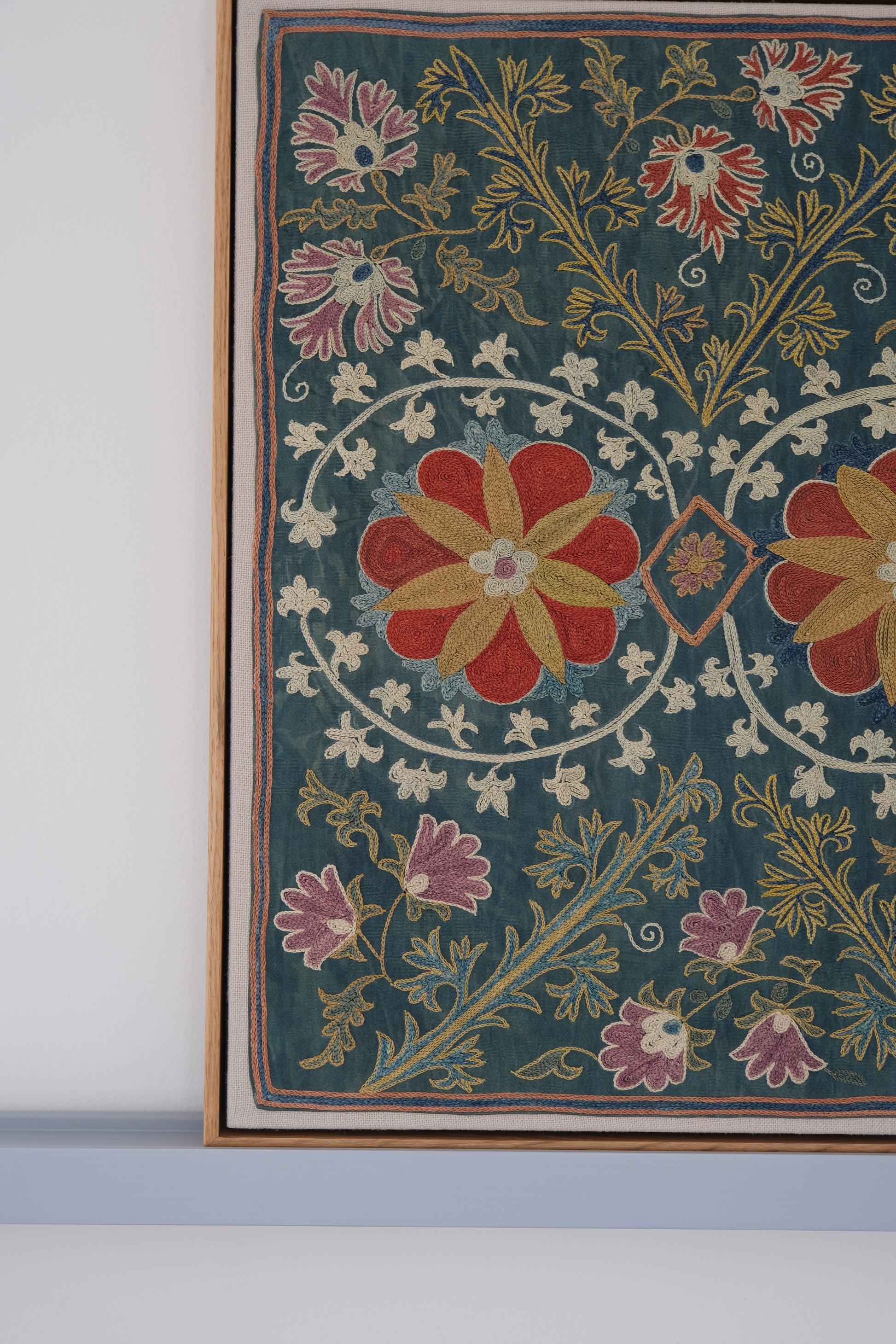 Framed suzani, embroidered textile art, wooden frame, green with floral motifs