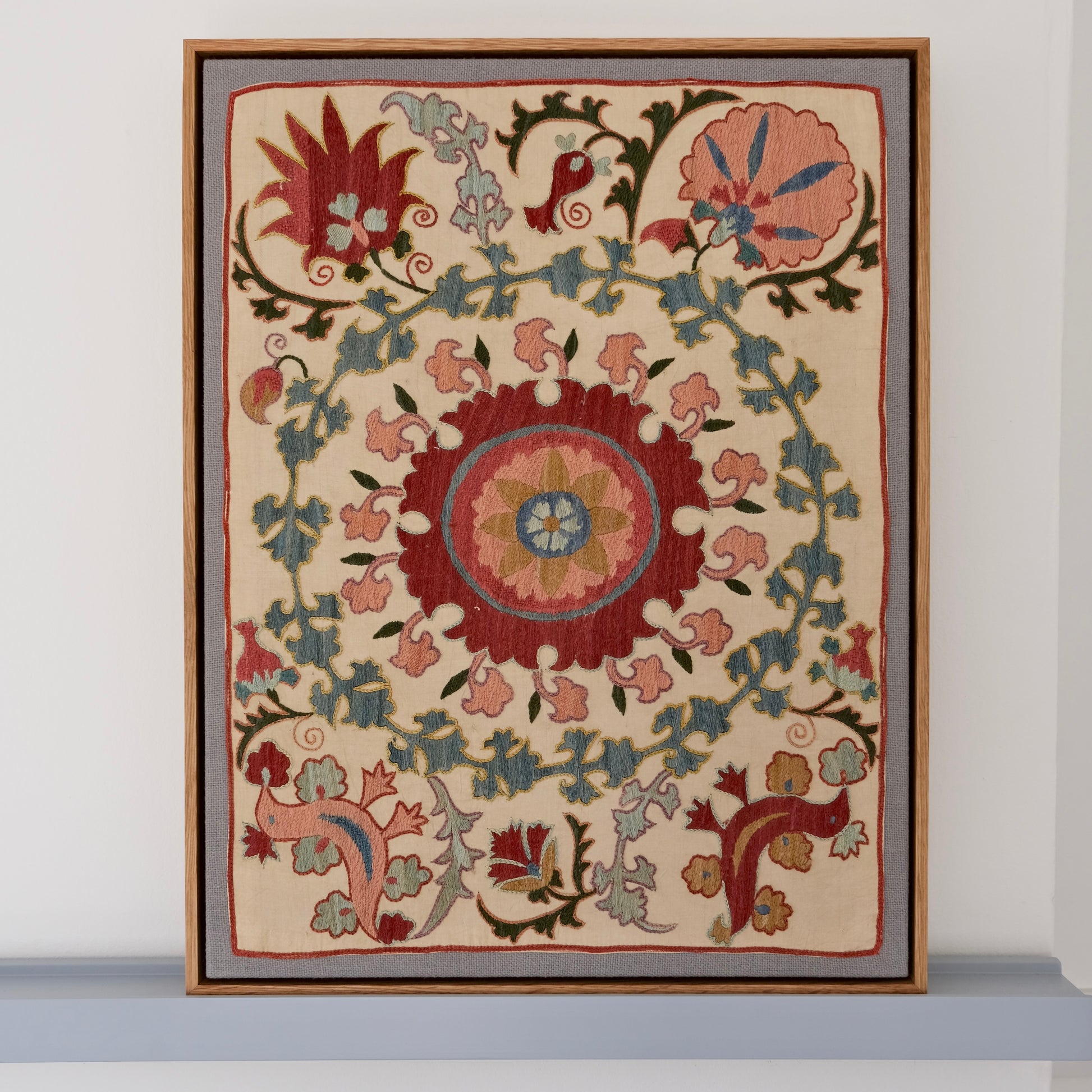 Framed suzani, embroidered textile art, wooden frame, white with pink and blue bird design