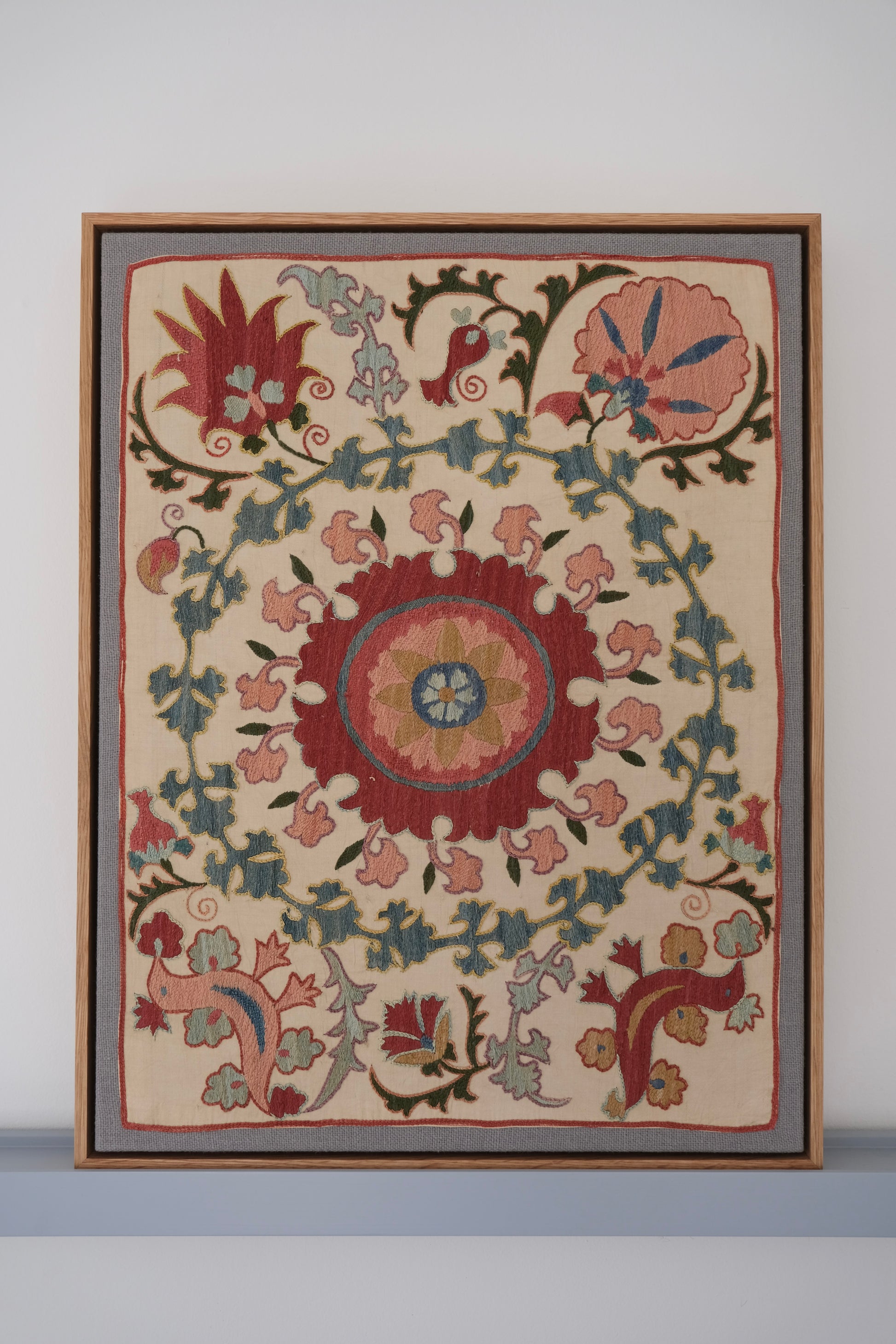 Framed suzani, embroidered textile art, wooden frame, white with pink and blue bird design