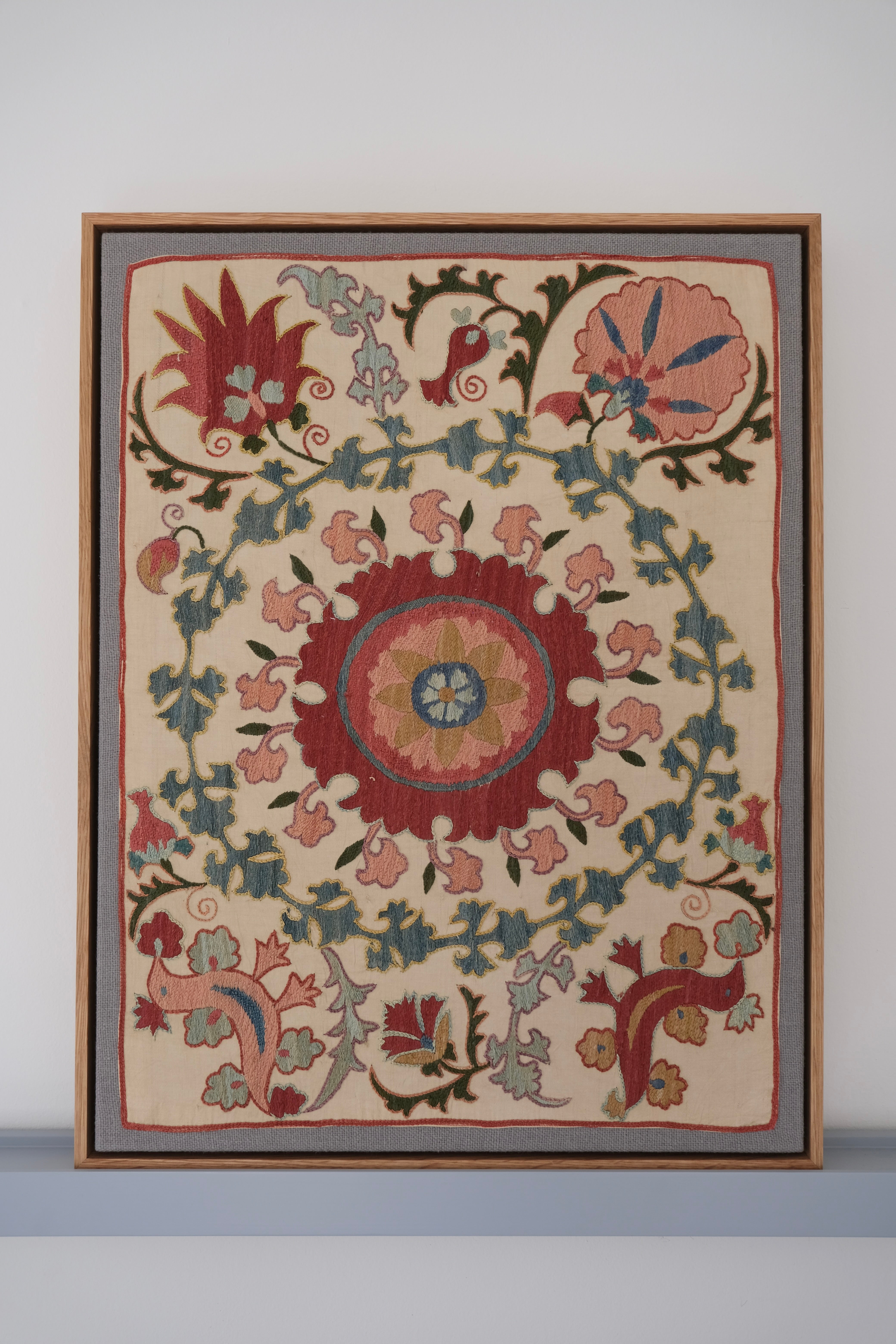 Framed suzani, embroidered textile art, wooden frame, white with pink and blue bird design