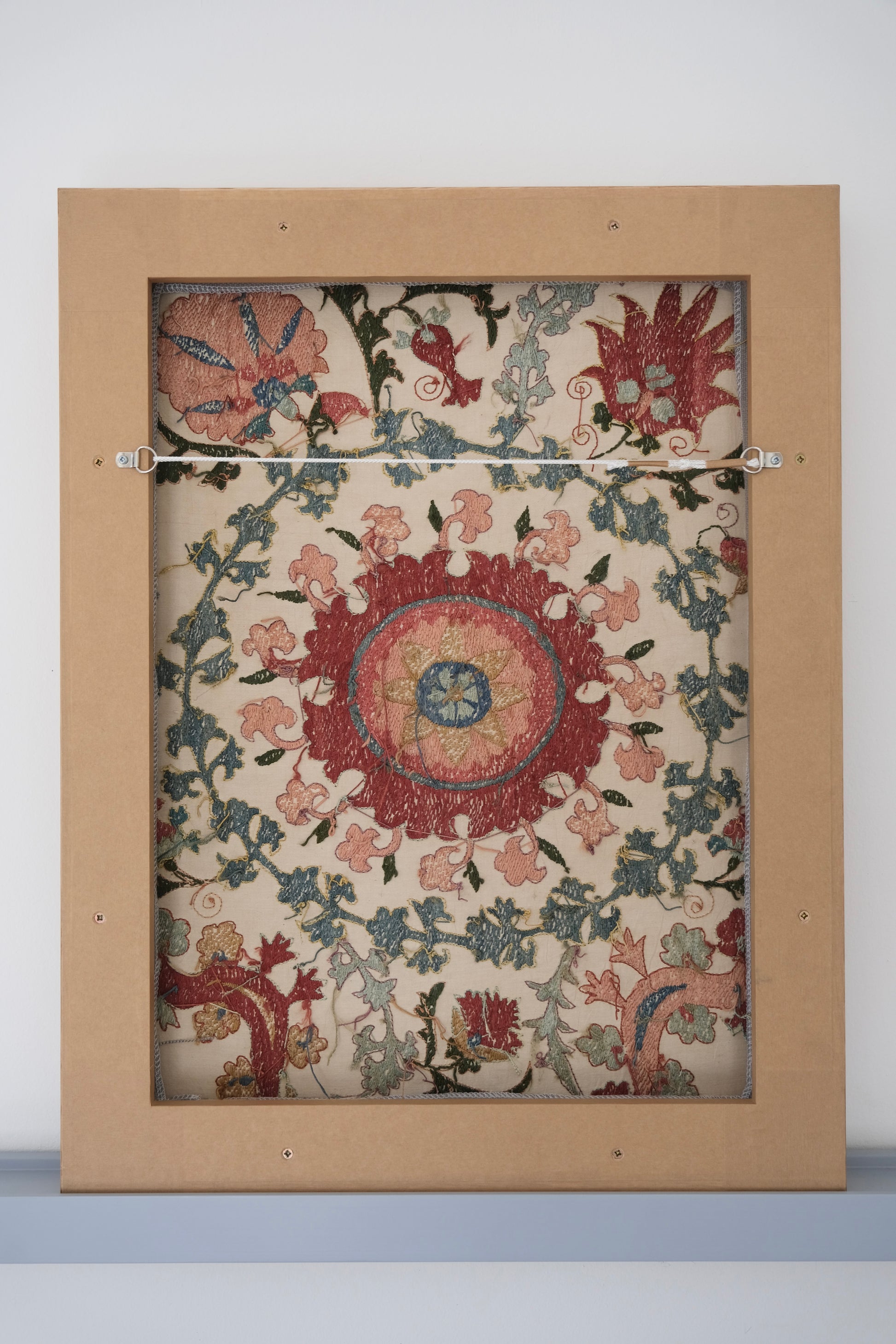 Framed suzani, embroidered textile art, wooden frame, white with pink and blue bird design, backside