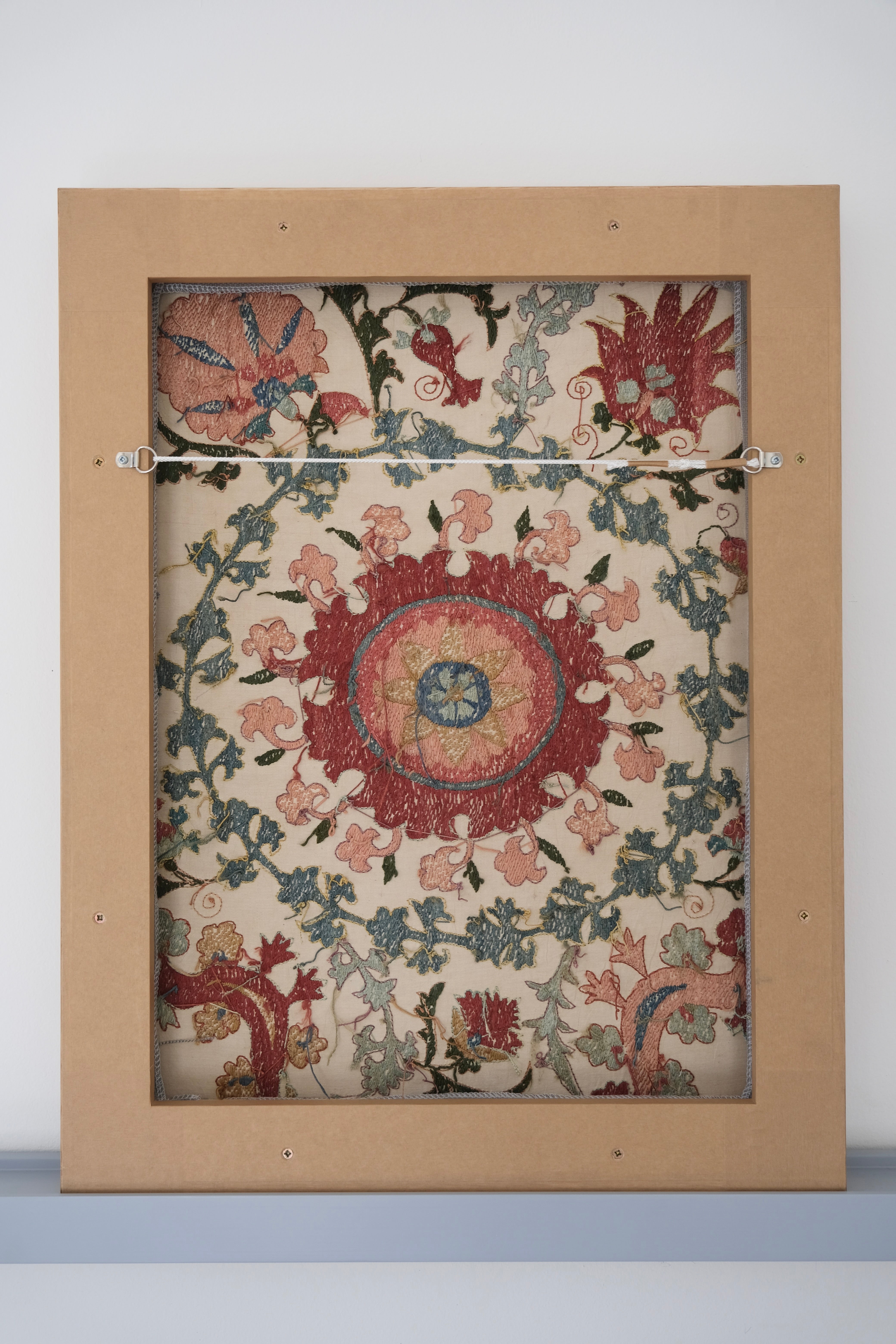 Framed suzani, embroidered textile art, wooden frame, white with pink and blue bird design, backside