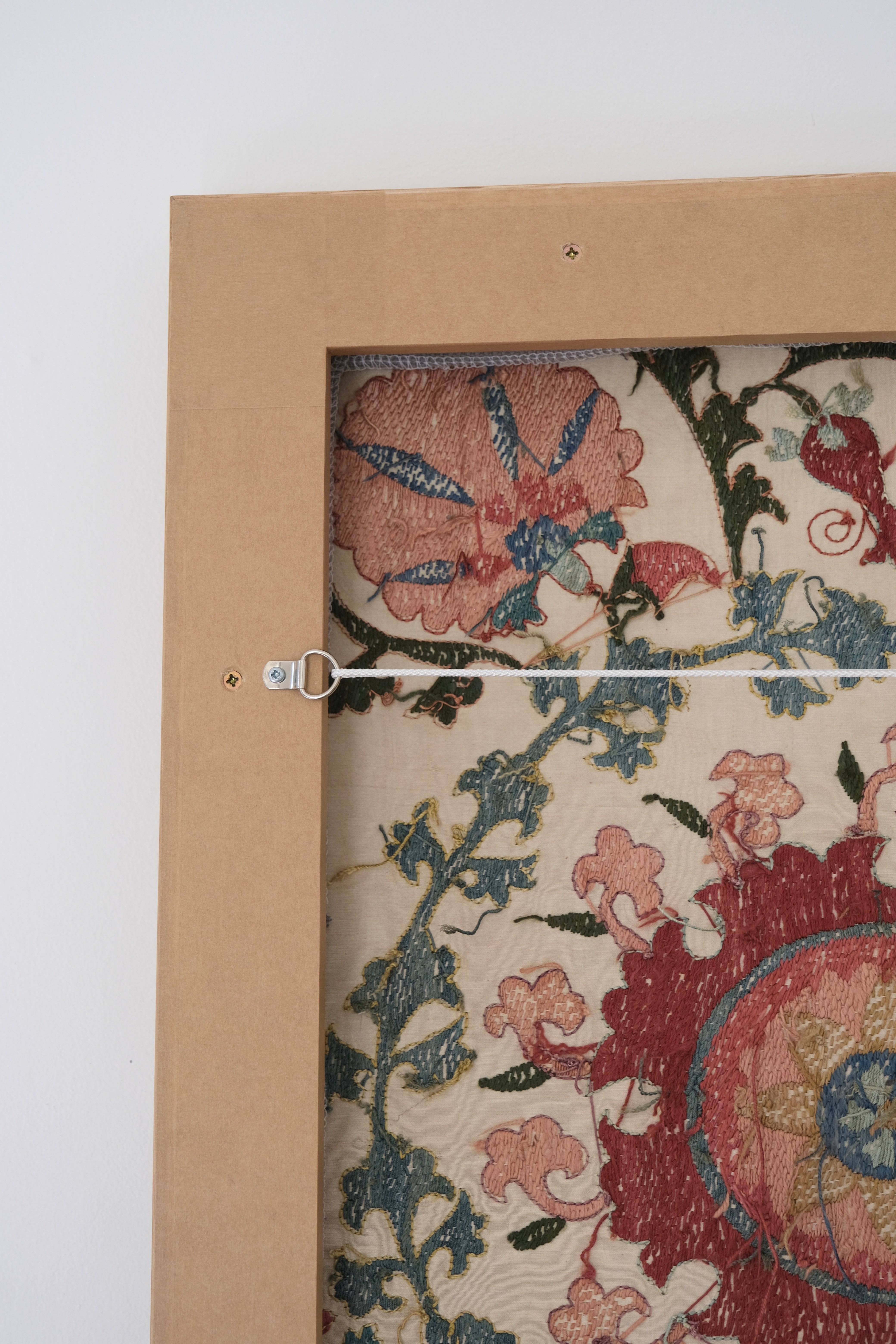 Framed suzani, embroidered textile art, wooden frame, white with pink and blue bird design, backside