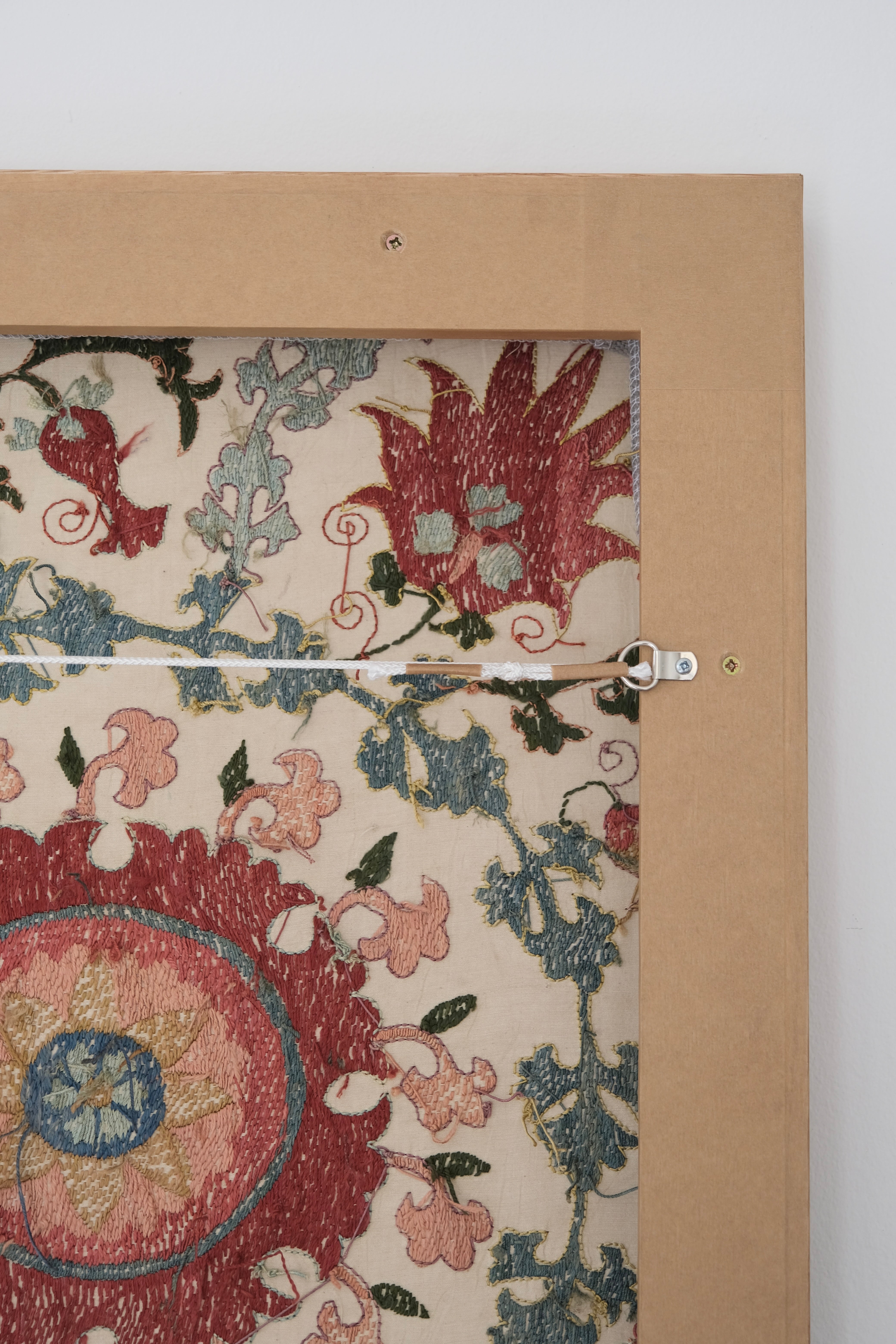 Framed suzani, embroidered textile art, wooden frame, white with pink and blue bird design, backside