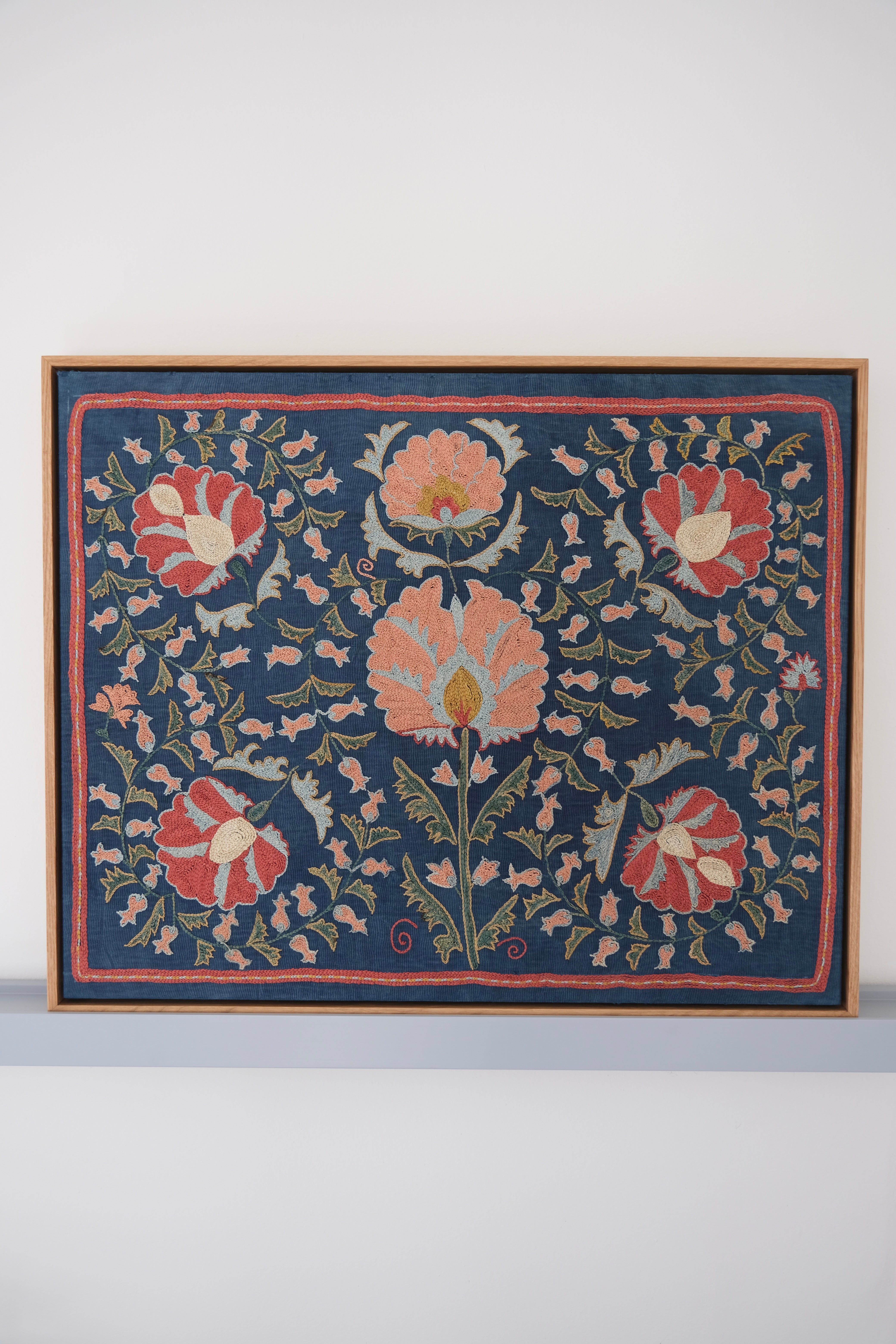 Framed suzani, embroidered textile art, wooden frame, navy blue with floral motifs