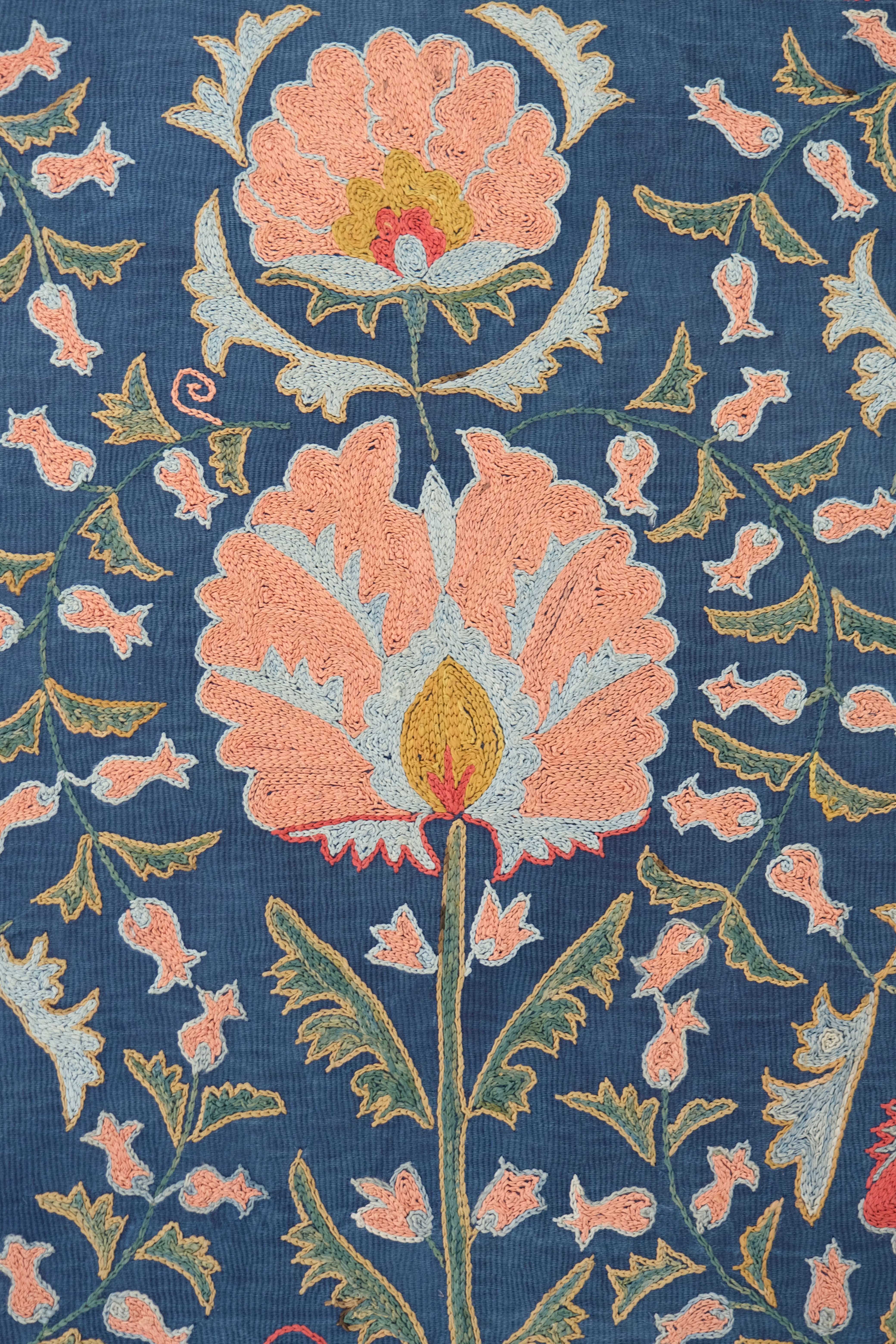 Framed suzani, embroidered textile art, wooden frame, navy blue with floral motifs, close-up
