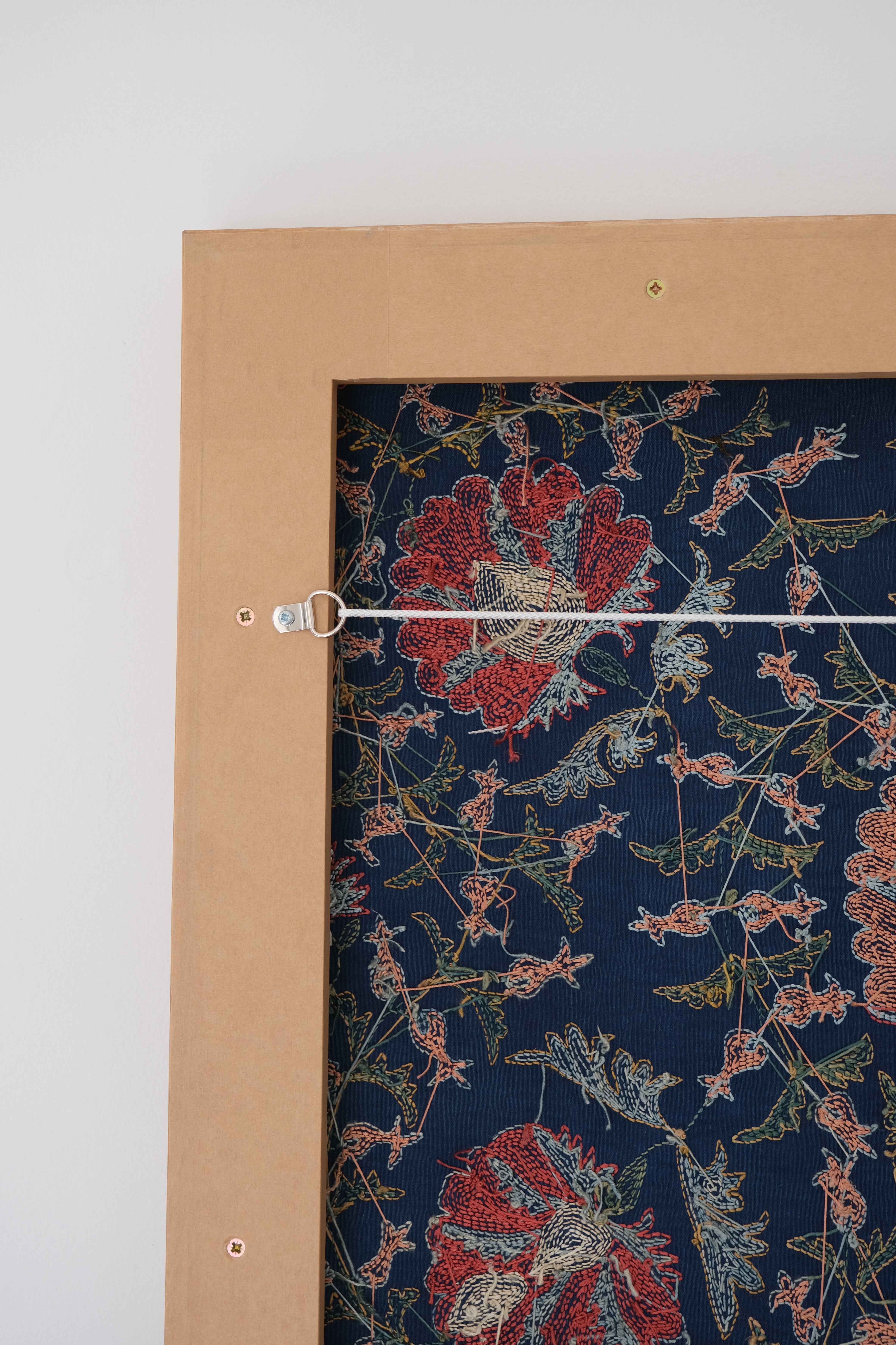 Framed suzani, embroidered textile art, wooden frame, navy blue with floral motifs, backside