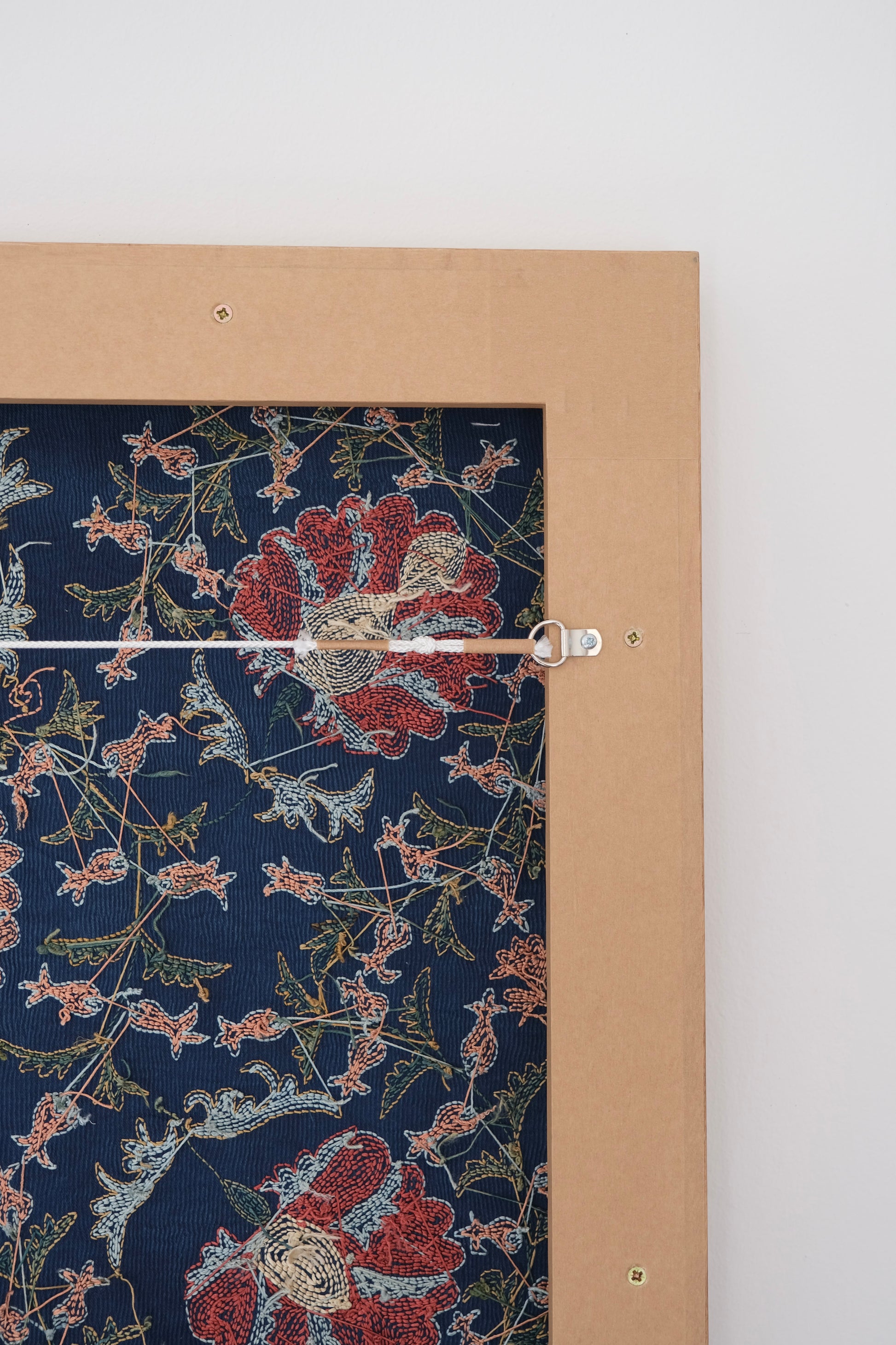 Framed suzani, embroidered textile art, wooden frame, navy blue with floral motifs, backside