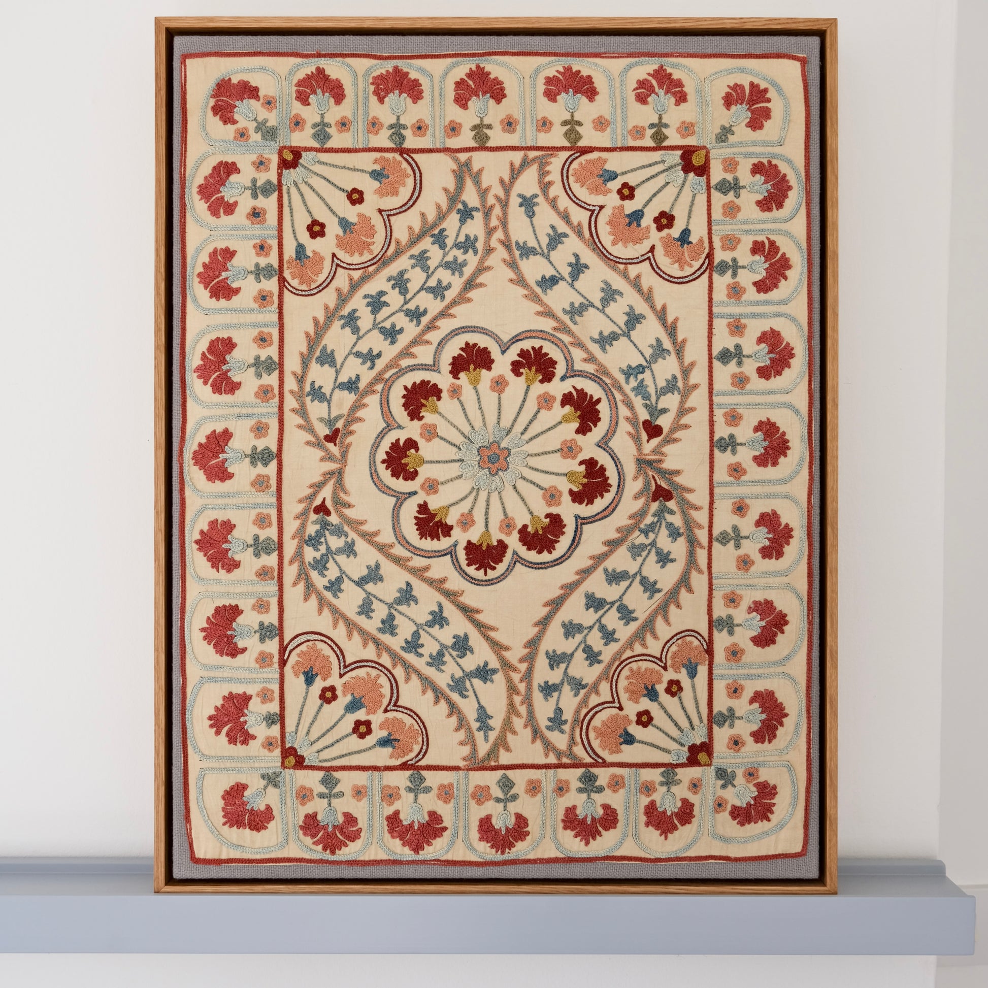Framed suzani, embroidered textile art, wooden frame, white with blue and pink design