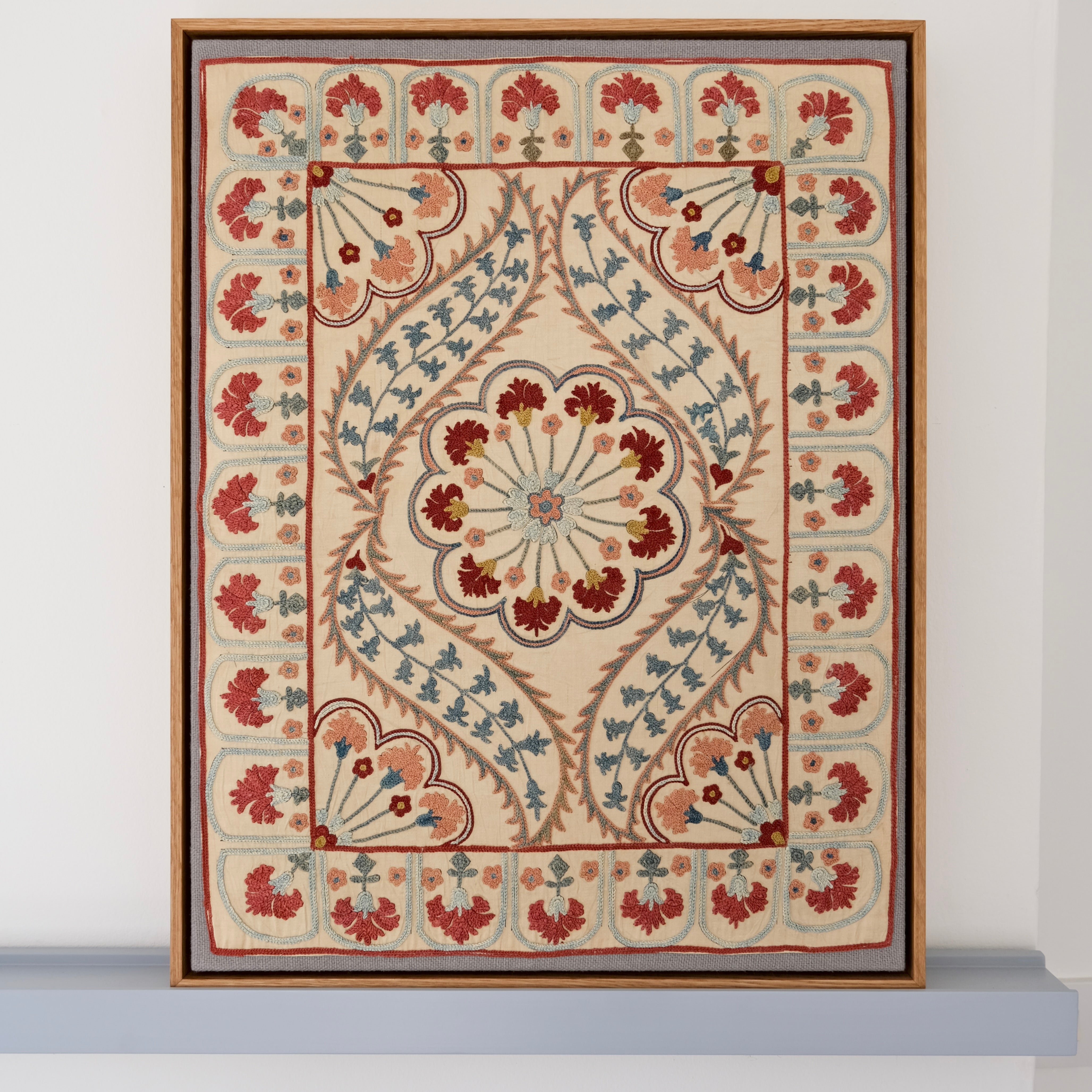 Framed suzani, embroidered textile art, wooden frame, white with blue and pink design