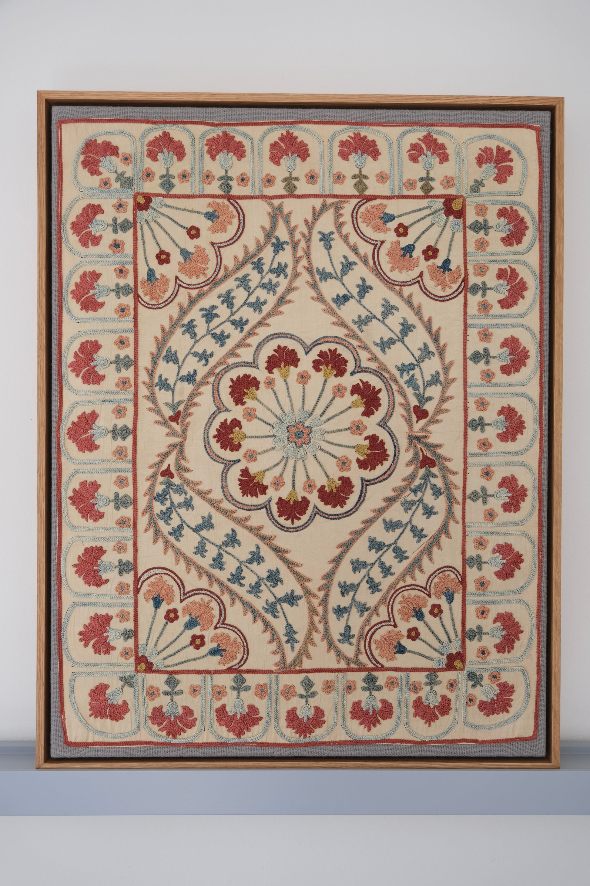 Framed suzani, embroidered textile art, wooden frame, white with blue and pink design