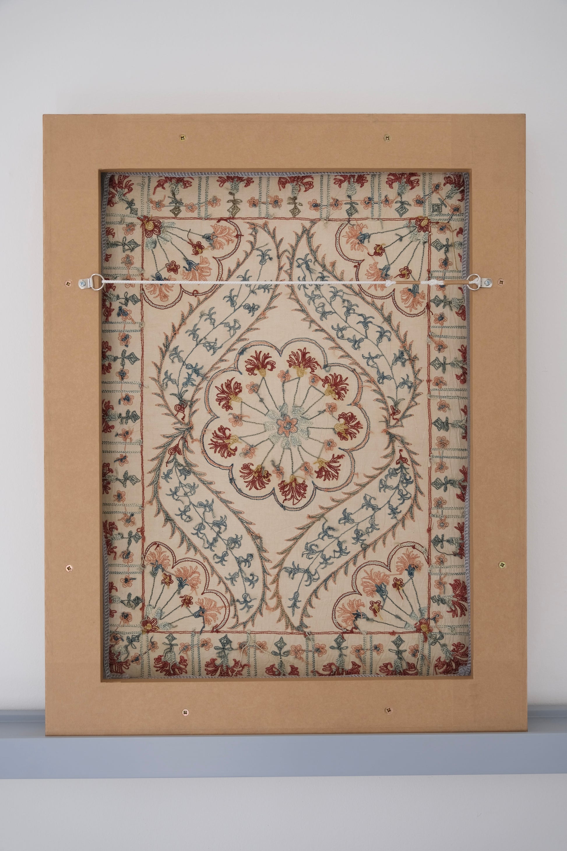 Framed suzani, embroidered textile art, wooden frame, white with blue and pink design, backside