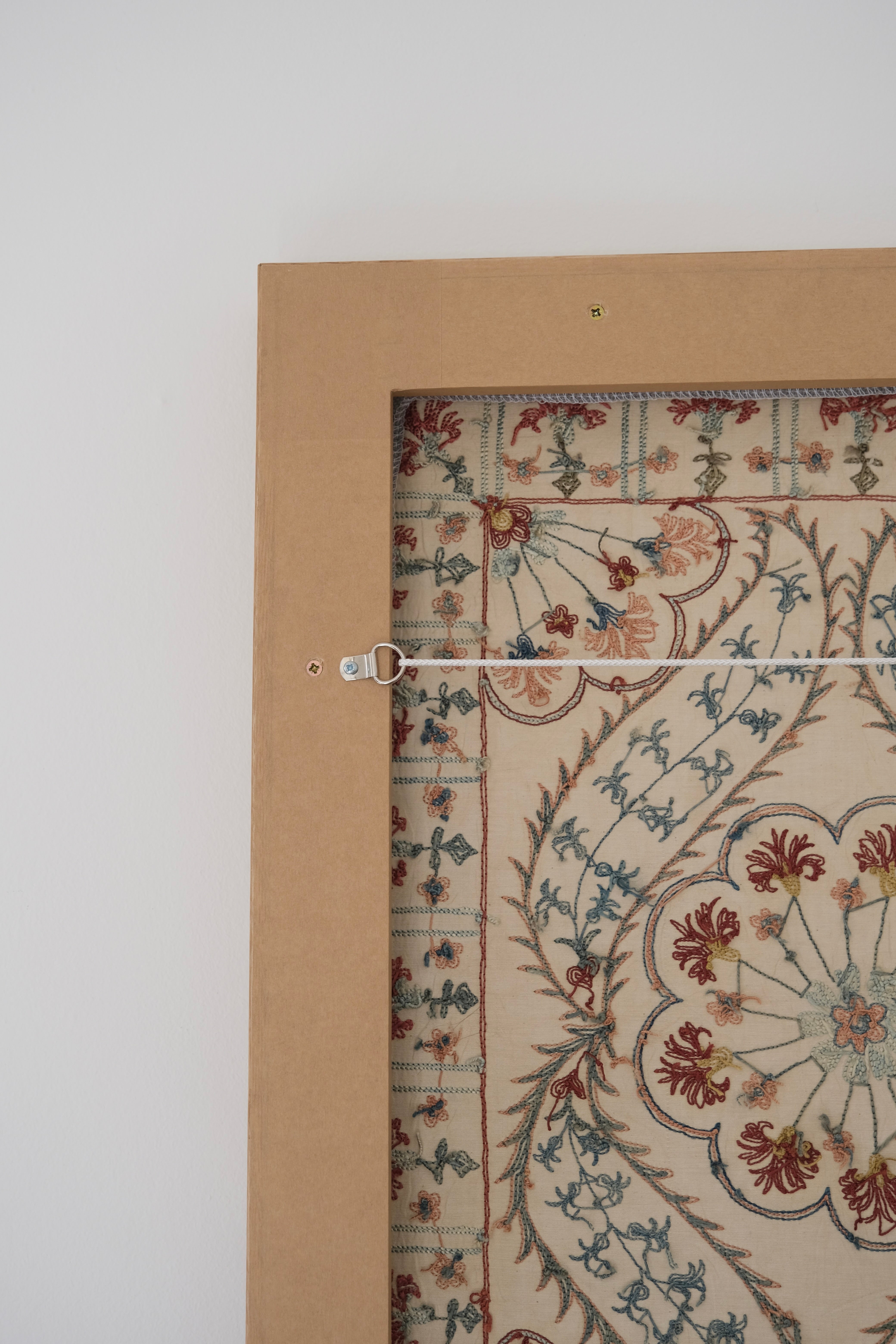 Framed suzani, embroidered textile art, wooden frame, white with blue and pink design, backside