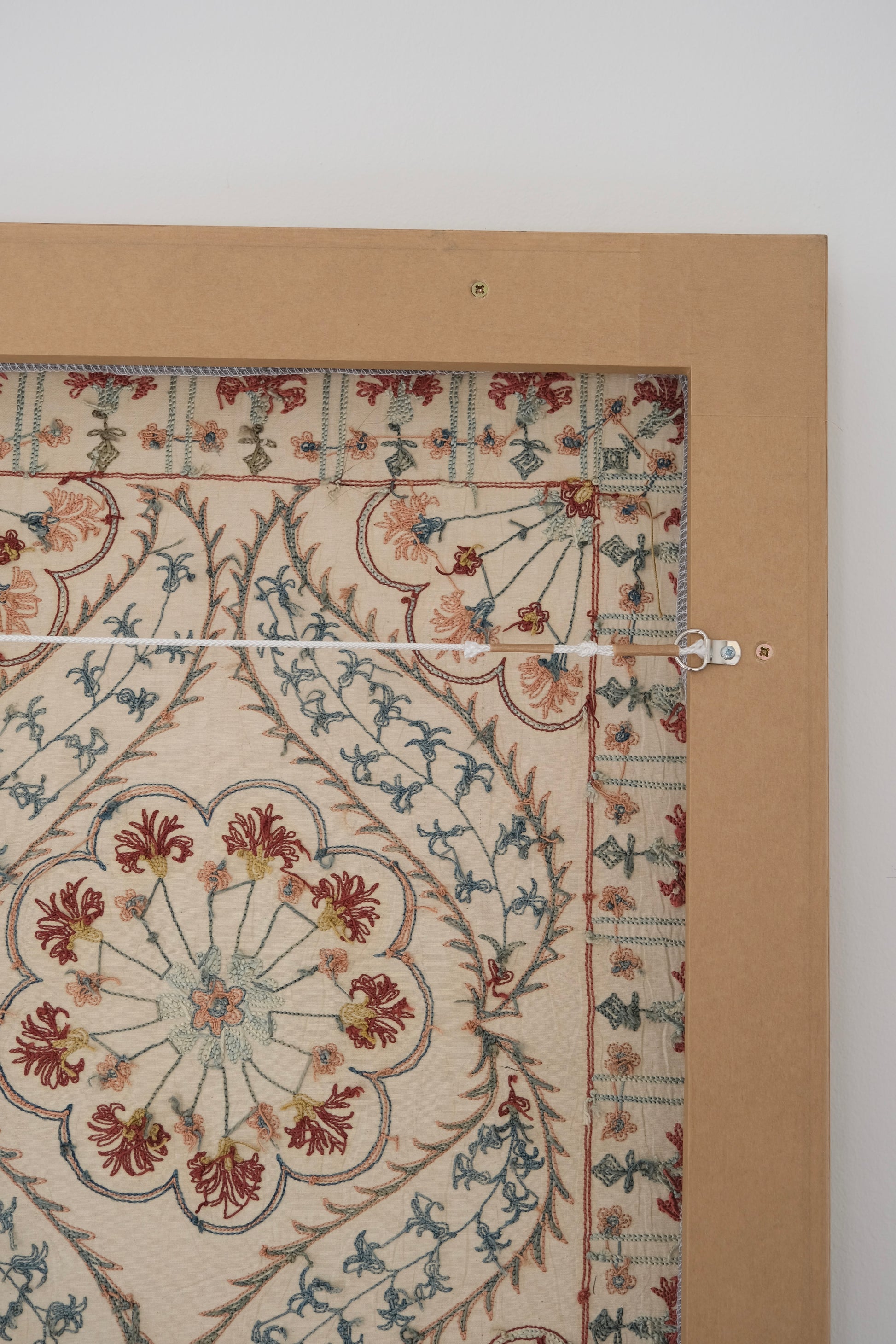 Framed suzani, embroidered textile art, wooden frame, white with blue and pink design, backside