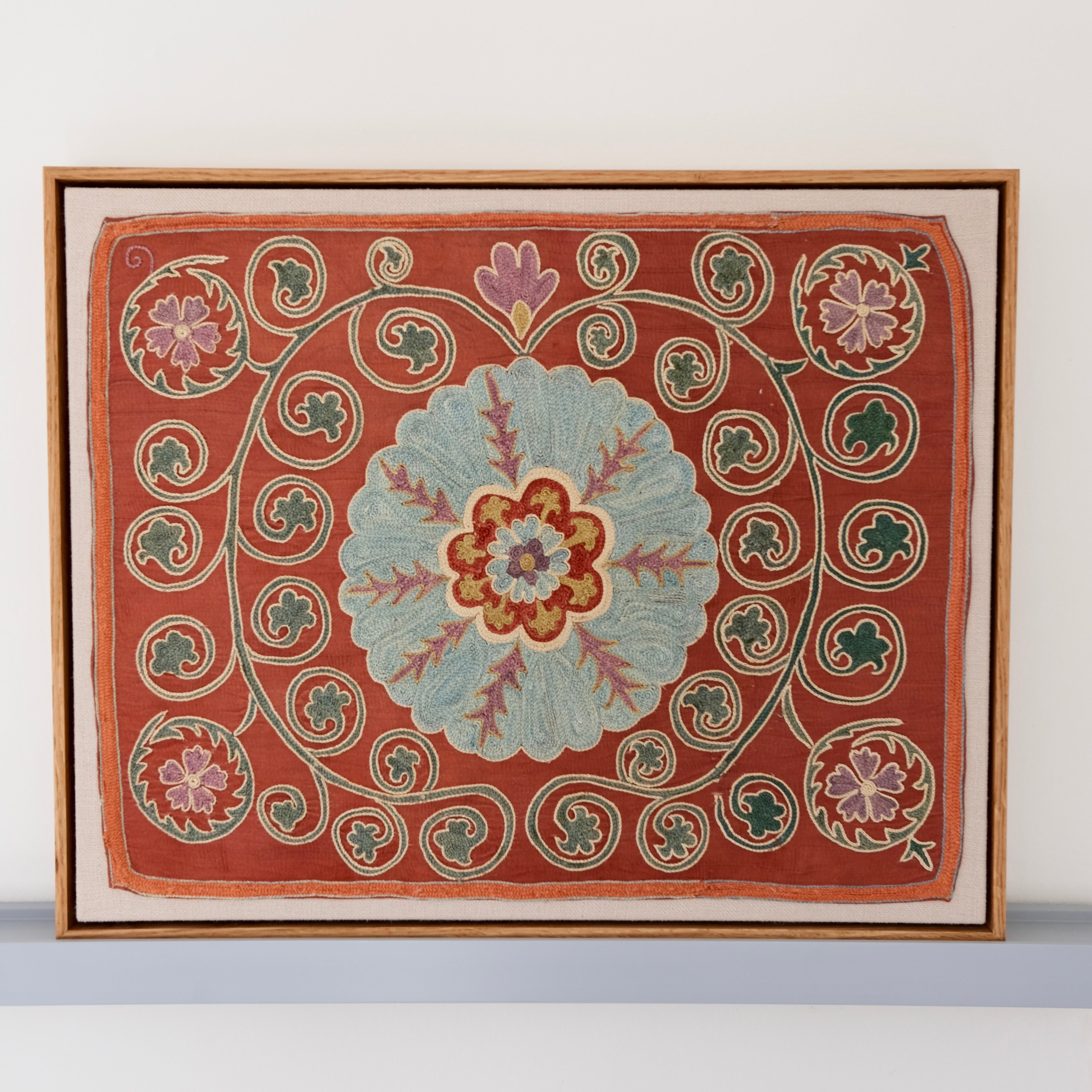 Framed suzani, embroidered textile art, wooden frame, dark orange and blue floral design